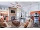Inviting living room featuring a stone fireplace, a ceiling fan and open to the kitchen and dining area at 902 W Saragosa St, Chandler, AZ 85225