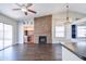 Cozy living area featuring a stone fireplace, a built-in bar, and sliding glass doors at 902 W Saragosa St, Chandler, AZ 85225