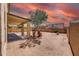 Large backyard featuring a covered patio, desert landscaping, and block fencing for privacy at 9423 W Monte Vista Rd, Phoenix, AZ 85037