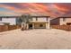 Expansive backyard showcasing desert landscaping, a covered patio, and perimeter fencing for privacy at 9423 W Monte Vista Rd, Phoenix, AZ 85037