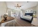 Cozy bedroom with a desk, ceiling fan, and ample natural light at 9423 W Monte Vista Rd, Phoenix, AZ 85037