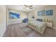 Serene bedroom with stylish artwork, a ceiling fan, and a cozy sitting area at 9423 W Monte Vista Rd, Phoenix, AZ 85037
