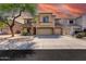 Inviting two-story home with a three-car garage and desert landscaping under a vibrant sunset sky at 9423 W Monte Vista Rd, Phoenix, AZ 85037