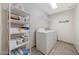 Functional laundry room with shelving and a washer and dryer at 9423 W Monte Vista Rd, Phoenix, AZ 85037