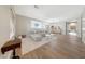 Spacious and bright living area with wood floors, a comfortable gray sofa, and large windows at 9423 W Monte Vista Rd, Phoenix, AZ 85037