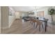 Open-concept living and dining area with a modern chandelier and stylish furniture at 9423 W Monte Vista Rd, Phoenix, AZ 85037