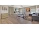 Bright living room with wood flooring, modern furnishings, and sliding glass door access to the outdoors at 9423 W Monte Vista Rd, Phoenix, AZ 85037