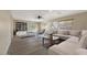 Generously sized living room with plush sofas, wood flooring, and ample natural light from large windows at 9423 W Monte Vista Rd, Phoenix, AZ 85037