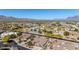 Expansive aerial view showcasing a desert landscape community, mountain views, and Arizona's clear blue sky at 1019 N Tambor Cir, Mesa, AZ 85207