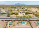 Wide angle aerial view of residential neighborhood with lush trees and mountain views at 1019 N Tambor Cir, Mesa, AZ 85207