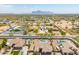 Expansive aerial view of community with sparkling pools and mountain views at 1019 N Tambor Cir, Mesa, AZ 85207