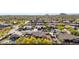 Scenic aerial view of a peaceful desert neighborhood, well-manicured lawns, beautiful desert foliage and lush landscaping at 1019 N Tambor Cir, Mesa, AZ 85207
