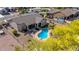 Aerial view of a private backyard featuring a kidney-shaped pool, an outdoor kitchen, and desert landscaping at 1019 N Tambor Cir, Mesa, AZ 85207