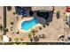 Overhead view of kidney-shaped pool, desert landscaping, a covered patio, and green space in private backyard at 1019 N Tambor Cir, Mesa, AZ 85207