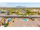 Charming aerial view of residential neighborhood with community park and mountain views at 1019 N Tambor Cir, Mesa, AZ 85207