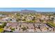 Community aerial view of homes surrounded by desert landscape and mountain views in the distance at 1019 N Tambor Cir, Mesa, AZ 85207
