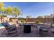Cozy backyard seating area with comfortable seating and a fire pit for outdoor gatherings and relaxation at 1019 N Tambor Cir, Mesa, AZ 85207