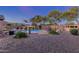 Expansive backyard featuring desert landscaping, a sparkling pool, outdoor seating, and a relaxing ambiance with desert views at 1019 N Tambor Cir, Mesa, AZ 85207