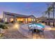 Stunning backyard with a sparkling pool, outdoor dining area, lush landscaping, and cozy seating for ultimate relaxation at 1019 N Tambor Cir, Mesa, AZ 85207