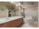 Bathroom features double sinks, vanity, soaking tub, and a separate glass door shower at 1019 N Tambor Cir, Mesa, AZ 85207