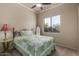 Bright bedroom with a cozy bed, a ceiling fan, and a window offering natural light at 1019 N Tambor Cir, Mesa, AZ 85207