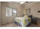 Comfortable bedroom features a ceiling fan and a large window that provides plenty of natural light at 1019 N Tambor Cir, Mesa, AZ 85207