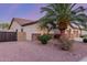 Landscaped side yard with desert rock and a privacy gate with a glimpse of the home's exterior at 1019 N Tambor Cir, Mesa, AZ 85207