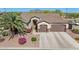Charming home featuring a two-car garage, desert landscaping, and a welcoming entrance at 1019 N Tambor Cir, Mesa, AZ 85207