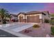 Well-maintained home with a three-car garage, desert landscaping, and an extended driveway at 1019 N Tambor Cir, Mesa, AZ 85207