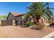 Charming exterior view showcasing desert landscaping, a two-car garage, and a side gate for easy access at 1019 N Tambor Cir, Mesa, AZ 85207