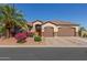 Inviting single-story home with a well-manicured desert landscape, a two-car garage, and a welcoming entrance at 1019 N Tambor Cir, Mesa, AZ 85207