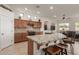 Modern kitchen island featuring granite countertops, ample seating, and stylish cabinetry, perfect for entertaining at 1019 N Tambor Cir, Mesa, AZ 85207