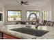 Close-up of the kitchen sink and granite countertop with a view into the living area at 1019 N Tambor Cir, Mesa, AZ 85207