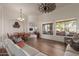 Bright open-concept living room with large windows, comfortable seating, and a dining area at 1019 N Tambor Cir, Mesa, AZ 85207