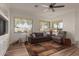 Bright living room featuring wood floors, comfortable seating, and scenic views from the large windows at 1019 N Tambor Cir, Mesa, AZ 85207