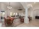 Spacious open-concept living room and dining area featuring tile floors and abundant natural light at 1019 N Tambor Cir, Mesa, AZ 85207