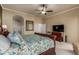 Spacious main bedroom features a large bed, ceiling fan, and access to the bathroom at 1019 N Tambor Cir, Mesa, AZ 85207