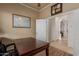 The office features a wooden desk, tile floors and is brightly lit by the open door at 1019 N Tambor Cir, Mesa, AZ 85207