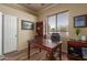 Office includes a wooden desk, and a built in bookcase with a large window at 1019 N Tambor Cir, Mesa, AZ 85207
