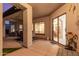 Covered patio showcasing an outdoor dining area for entertaining and an open doorway at 1019 N Tambor Cir, Mesa, AZ 85207