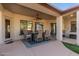 Covered patio features an outdoor dining area with ample seating, ceiling fan, and neutral tones at 1019 N Tambor Cir, Mesa, AZ 85207
