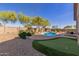 Backyard pool and putting green with desert landscaping create an outdoor oasis at 1019 N Tambor Cir, Mesa, AZ 85207