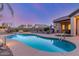 Inviting backyard oasis featuring a pristine pool and serene landscaping, perfect for outdoor relaxation and entertainment at 1019 N Tambor Cir, Mesa, AZ 85207