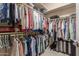 Walk-in closet with built-in racks and shelving provides ample storage for clothes and luggage at 1019 N Tambor Cir, Mesa, AZ 85207