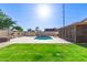 Beautiful backyard featuring a pool, lush green lawn, and cozy barbecue area at 1207 E Sequoia Dr, Phoenix, AZ 85024