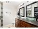 Bathroom featuring granite countertops, vessel sinks, decorative mirrors, and stylish vanity lighting at 1207 E Sequoia Dr, Phoenix, AZ 85024