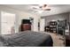 Bedroom with dark wood furniture, ceiling fan, and a full sized bed at 1207 E Sequoia Dr, Phoenix, AZ 85024