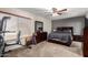 Bedroom with dark wood furniture, ceiling fan, and a full sized bed at 1207 E Sequoia Dr, Phoenix, AZ 85024