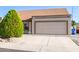 Attached two-car garage featuring a well-maintained driveway and tasteful front yard landscaping at 1207 E Sequoia Dr, Phoenix, AZ 85024