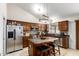 Modern kitchen featuring stainless steel appliances, dark cabinets, and center island seating at 1207 E Sequoia Dr, Phoenix, AZ 85024